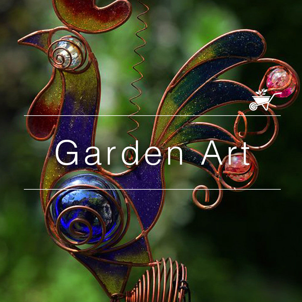 Colorful garden art sculpture of a rooster made from metal and glass, set in a lush outdoor space-myBageecha