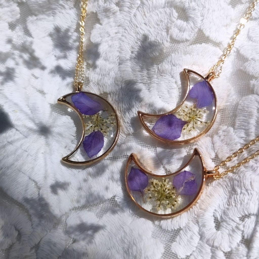 Wish Me a Moon necklace with real dried flowers preserved in crescent-shaped clear resin pendant