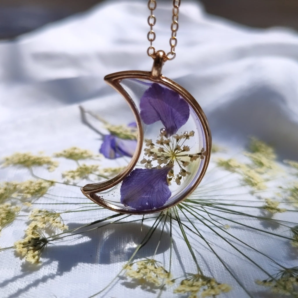 Artistic moon-theme necklace handcrafted with real dried blooms in transparent resin