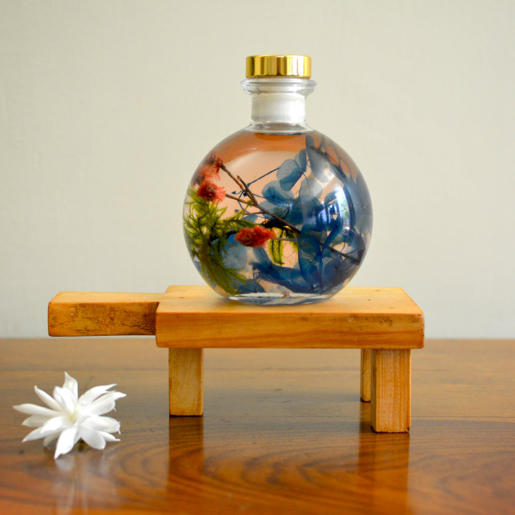 Coastal Zephyr Preserved Flower Tabletop on rectangular stand – marine-charm preserved arrangement.