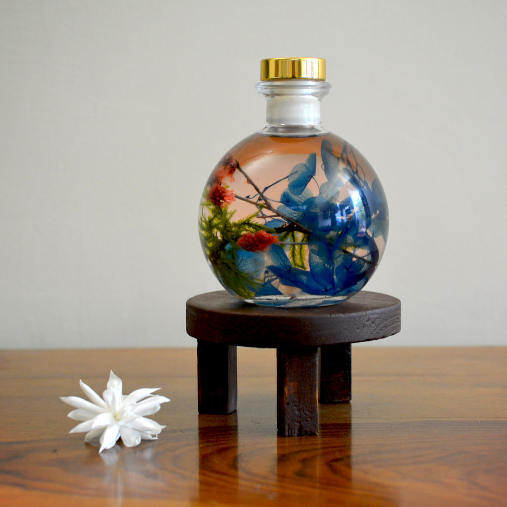 Coastal Zephyr Preserved Flower Tabletop on circular stand – ocean-inspired calming décor piece.