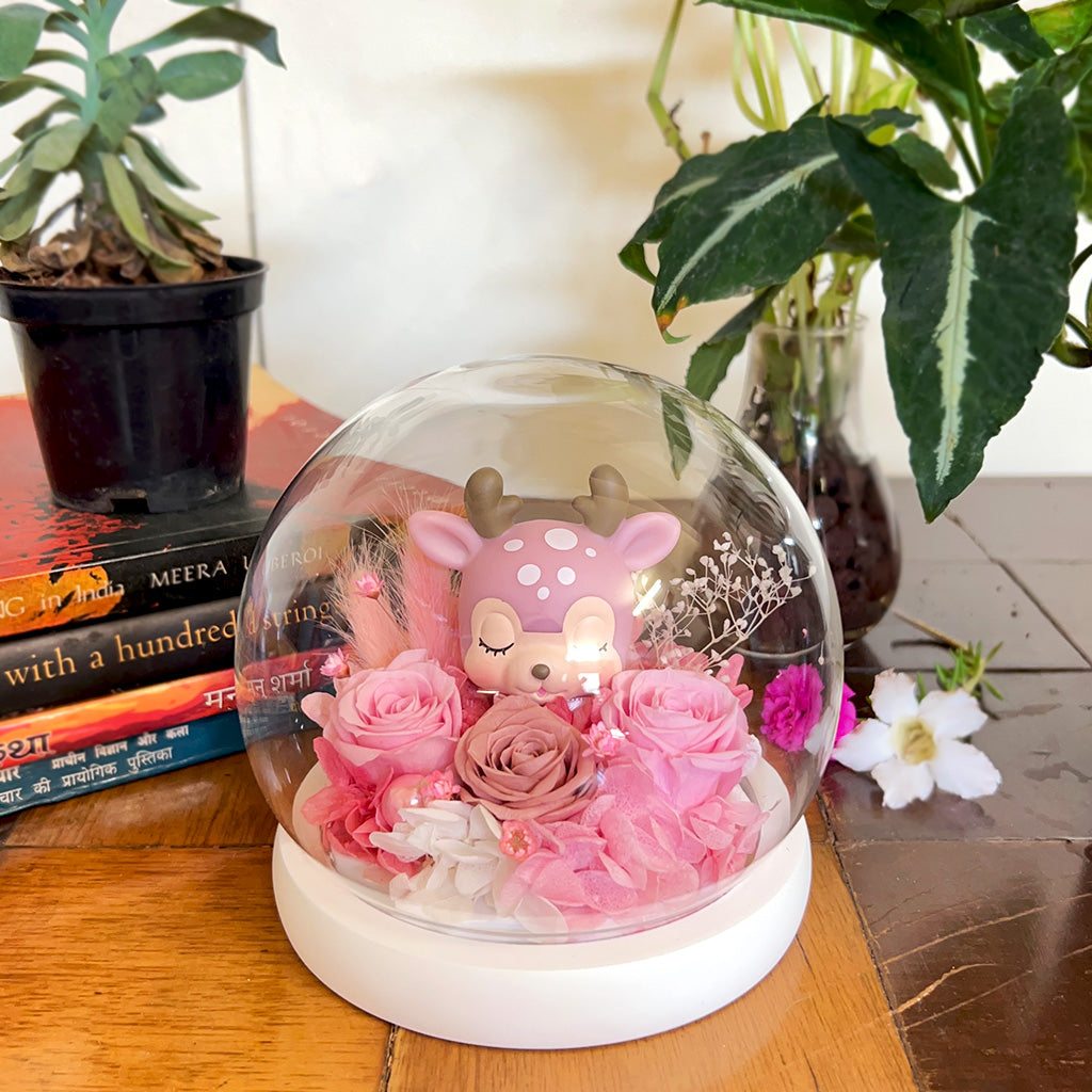 Deer Amidst Roses Preserved Flower Tabletop placed on table – soft romantic décor centerpiece.