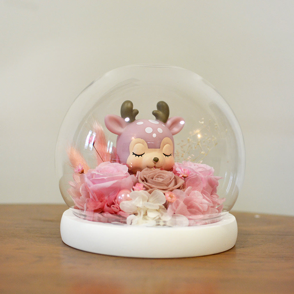 Close-up of Deer Amidst Roses preserved blooms with deer figurine accent.