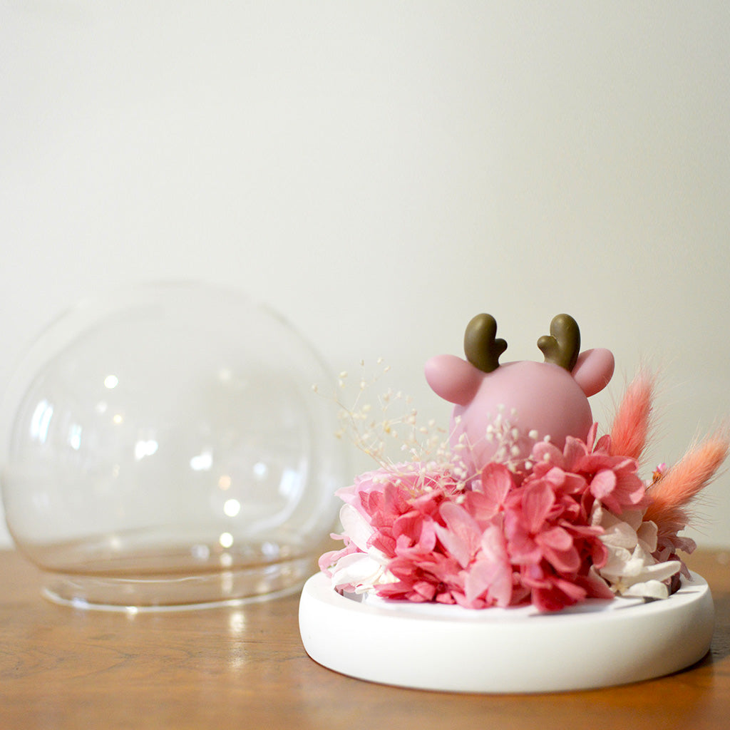 Close-up of Deer Amidst Roses preserved blooms with deer figurine accent.