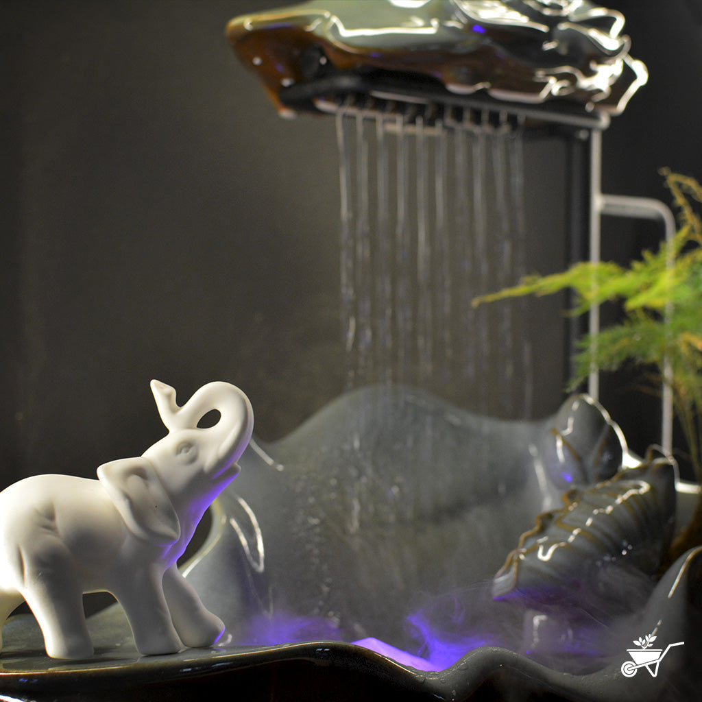 Elephant’s Oasis Water Fountain LED Decor Zen Garden – close-up of elephant figurines near water flow