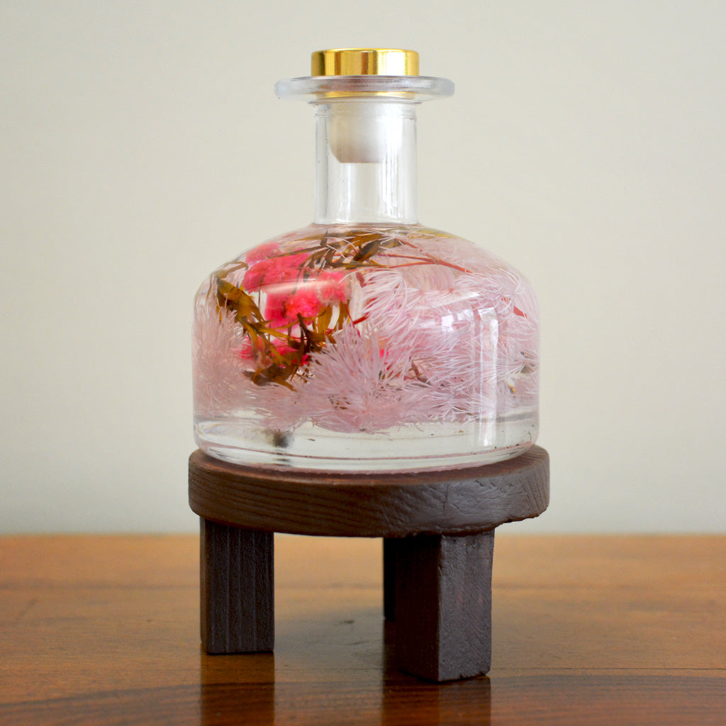Evening Primrose Preserved Flower Tabletop displayed on circular stand – charming preserved flower piece.