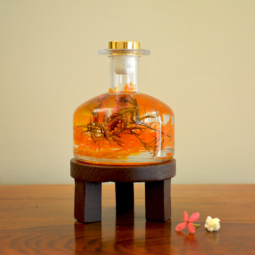 Golden Poppy Preserved Flower Tabletop on circular stand – vibrant preserved décor piece.