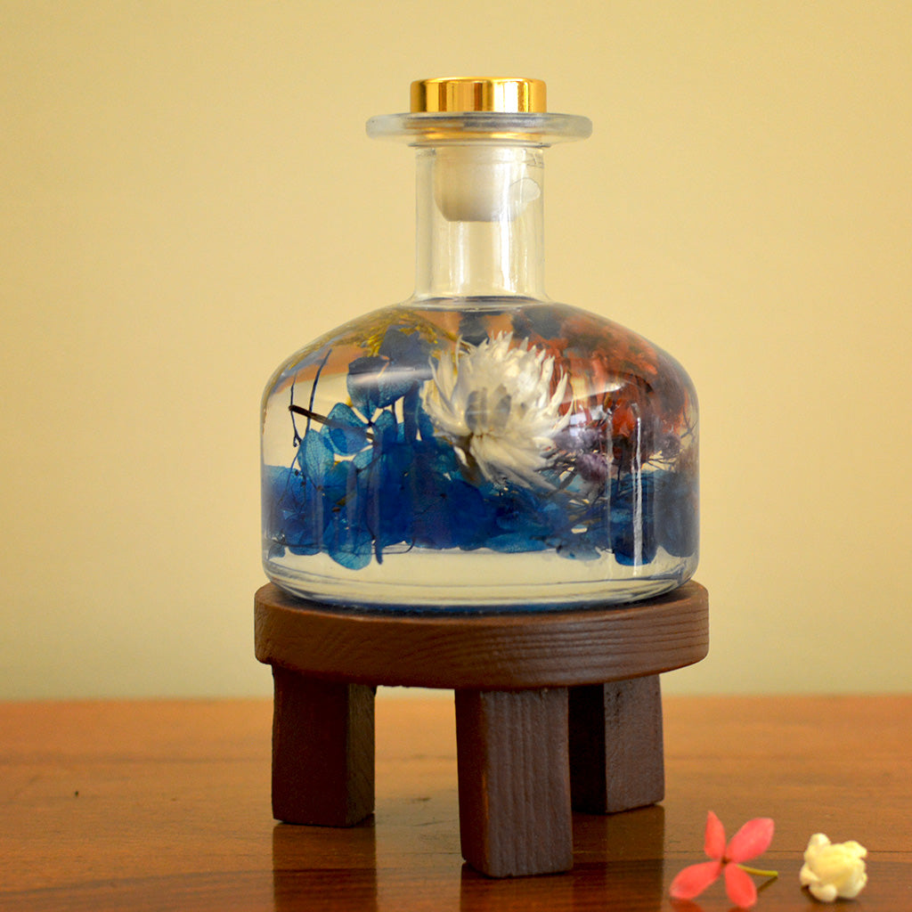 Gurgling Creek Preserved Flower Tabletop displayed on circular stand – natural serenity tabletop piece.