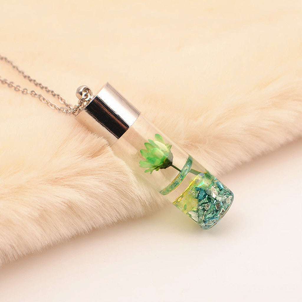 Green Lyrical Lotus resin pendant necklace showcasing real preserved floral charm