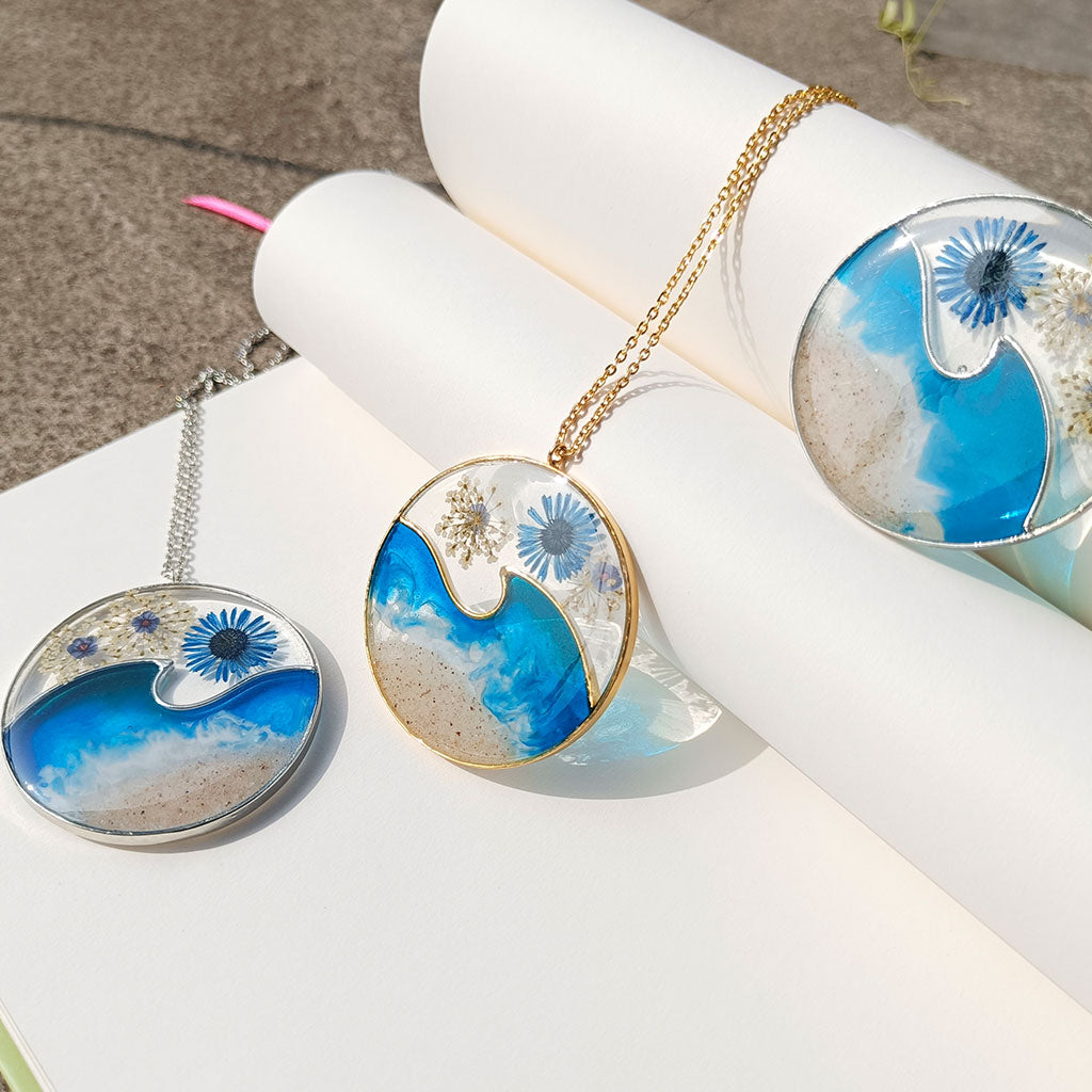Ocean Crest real dried flower necklace suspended on gold chain with wave design