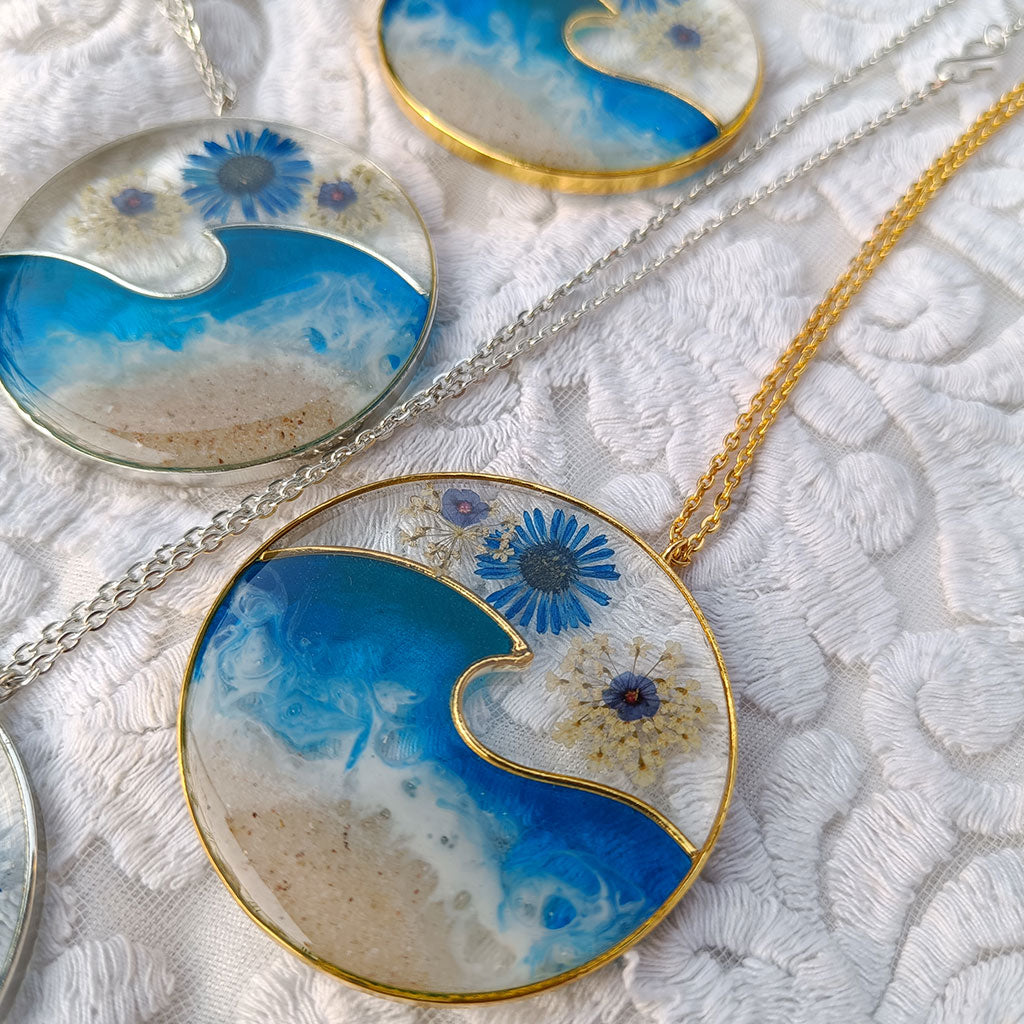 Ocean Crest botanical pendant featuring real preserved blooms in clear resin necklace