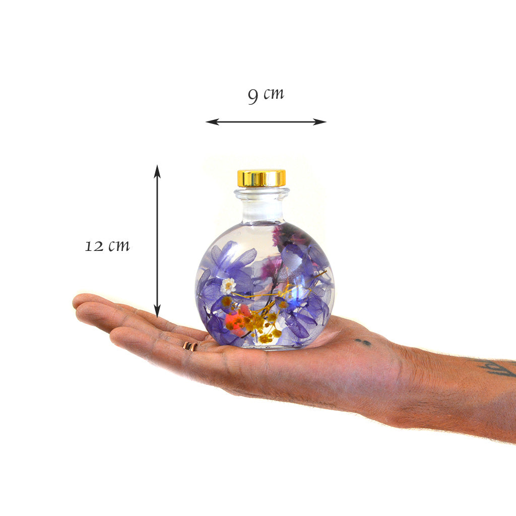 Plum Streak Preserved Flower Tabletop shown in hand – refined, bold preserved décor bottle.