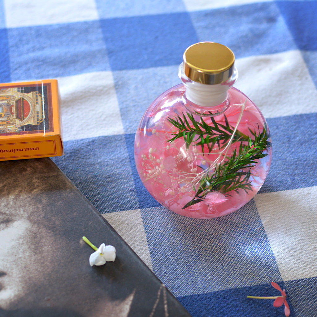 Rosy Twilight Preserved Flower Tabletop placed on table – floral & meadow-inspired interior accent.
