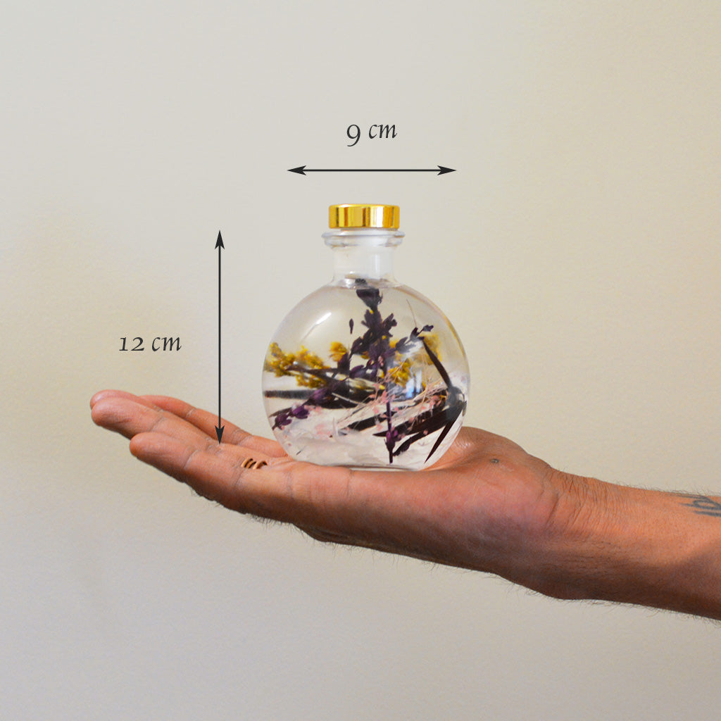 Snowdrop Lavender Preserved Flower Tabletop shown in hand to indicate compact elegant size.