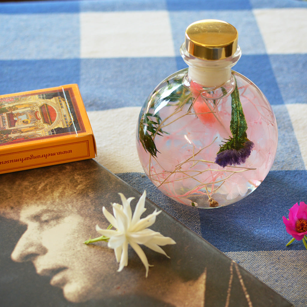 Swirling Salmon Preserved Flower Tabletop placed on table – soft peach décor accent.