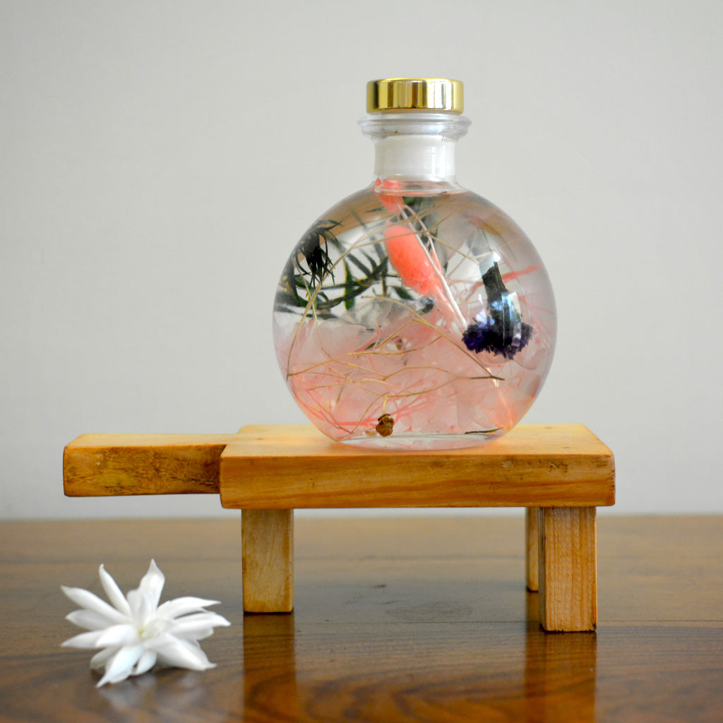 Swirling Salmon Preserved Flower Tabletop on rectangular stand – elegant pastel décor highlight.