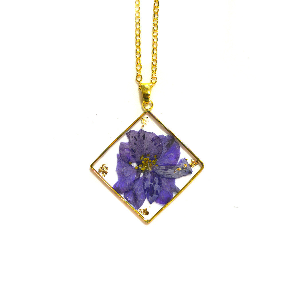 Close-up of Wisteria Whispers real flower pendant showing intricate resin clarity and floral detail