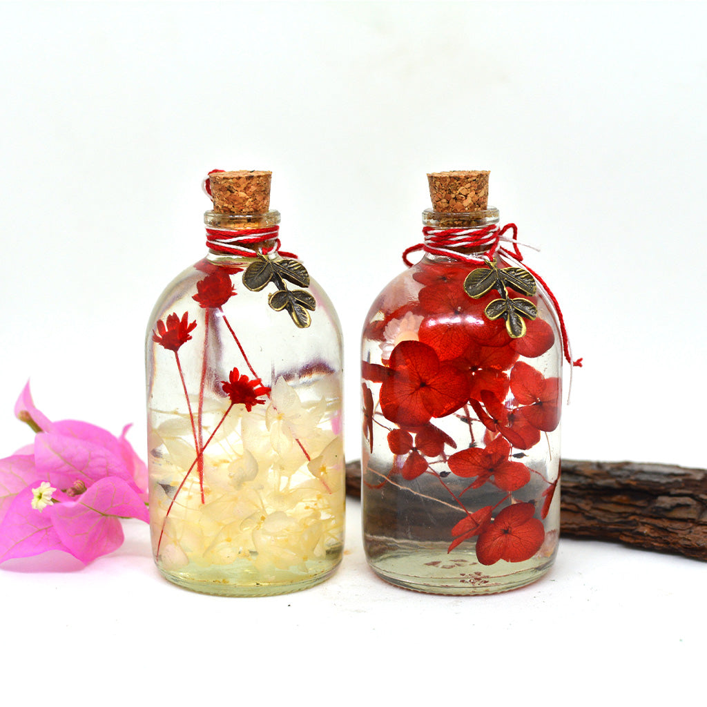 A symbolic balanced pairing of bold red and soft white hydrangea preserved bottles.