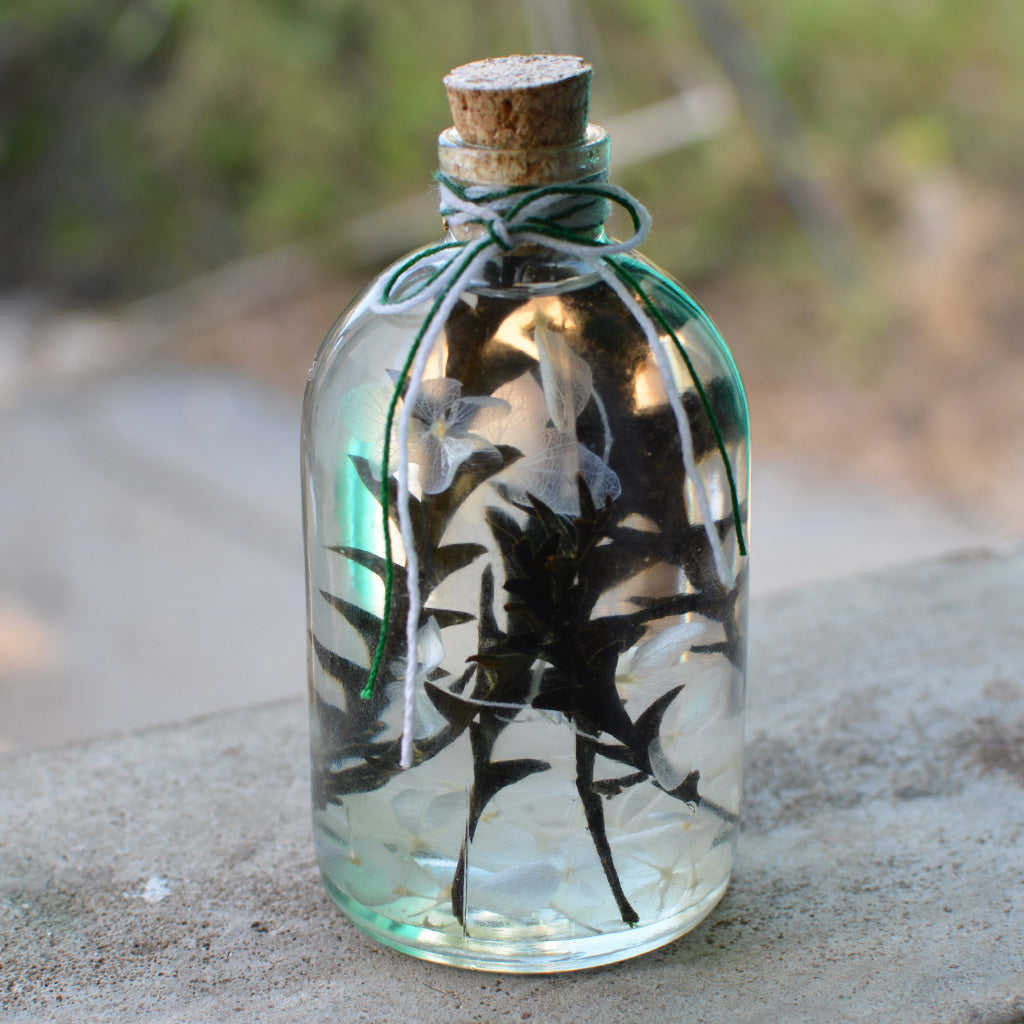 A playful woodland-inspired décor piece featuring preserved blooms and an owl motif.