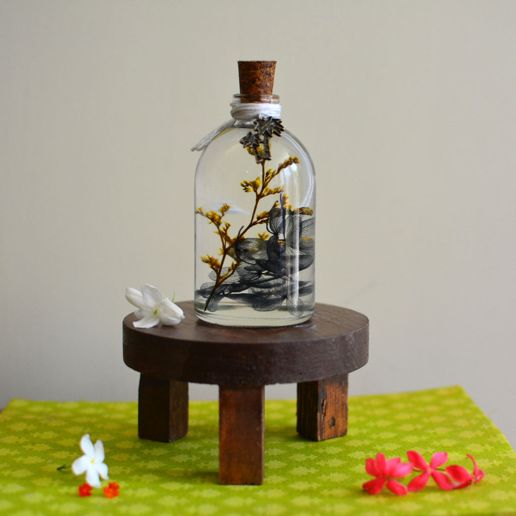 A Golden Lining Preserved Flower Tabletop on circular stand – glowing yellow décor centerpiece.
