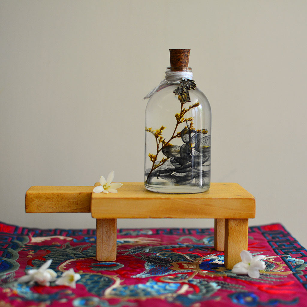 A Golden Lining Preserved Flower Tabletop on rectangular stand – warm preserved display.