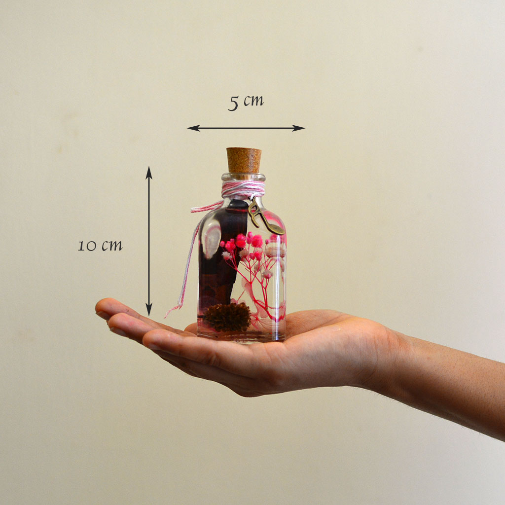 Adverse Allure Preserved Flower Tabletop shown in hand – dramatic decorative piece.