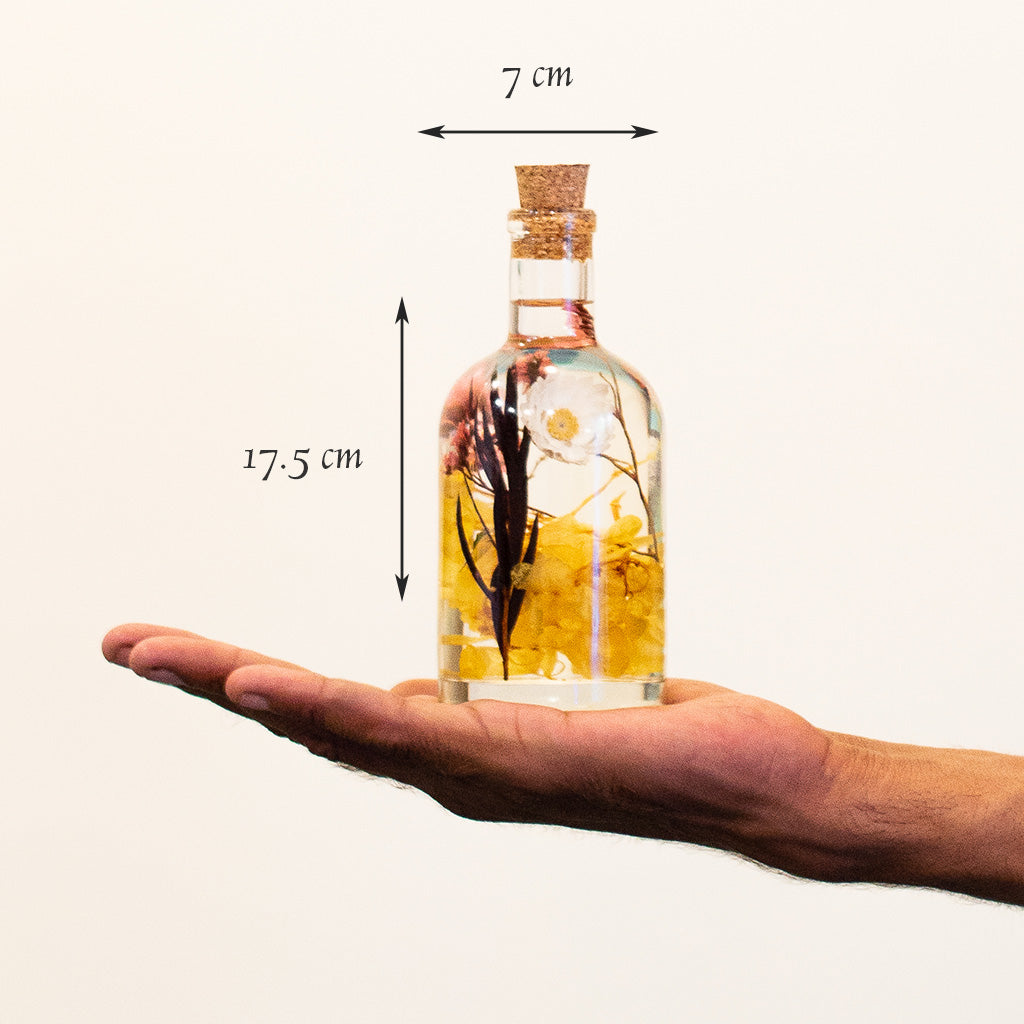 Baroque Carafe Preserved Flower Tabletop shown in hand – graceful elongated décor piece.