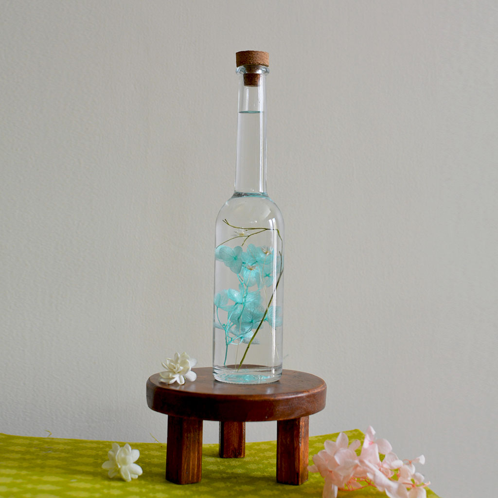 Blossoms of the Sky Preserved Flower Tabletop on circular stand – soothing centerpiece.