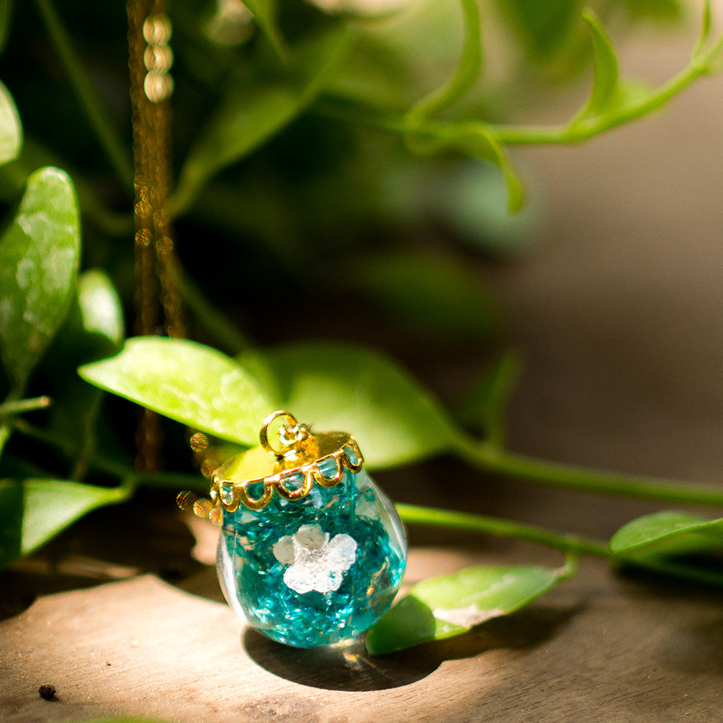 Boscage Tangle necklace with real dried green and brown foliage preserved in clear resin pendant