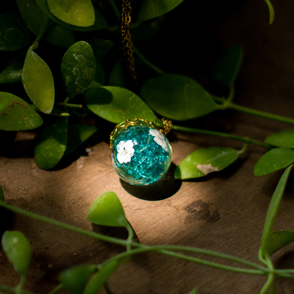 Handcrafted botanical resin necklace featuring preserved forest-inspired foliage and organic textures