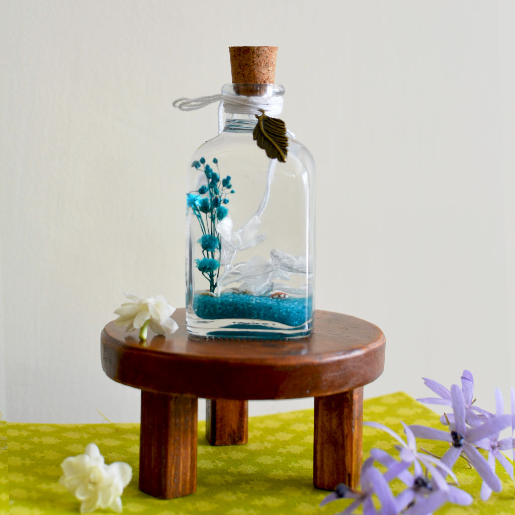 By The Bay Preserved Flower Tabletop on circular stand – soothing marine centerpiece.
