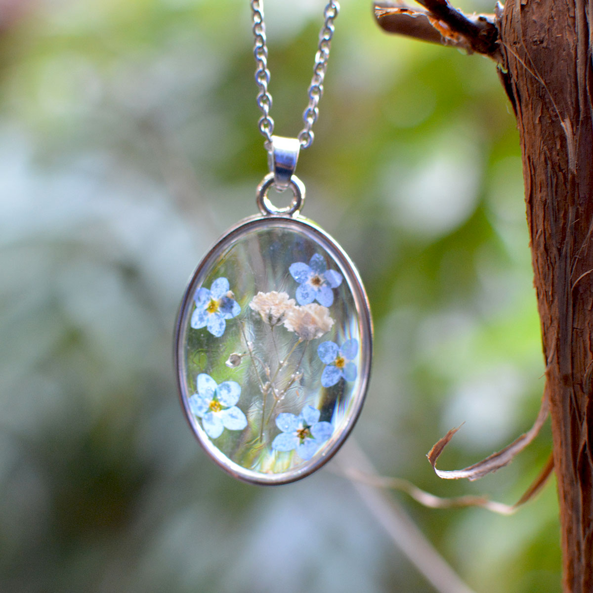 Contemplating Constellation necklace with real dried flowers preserved in deep blue resin pendant