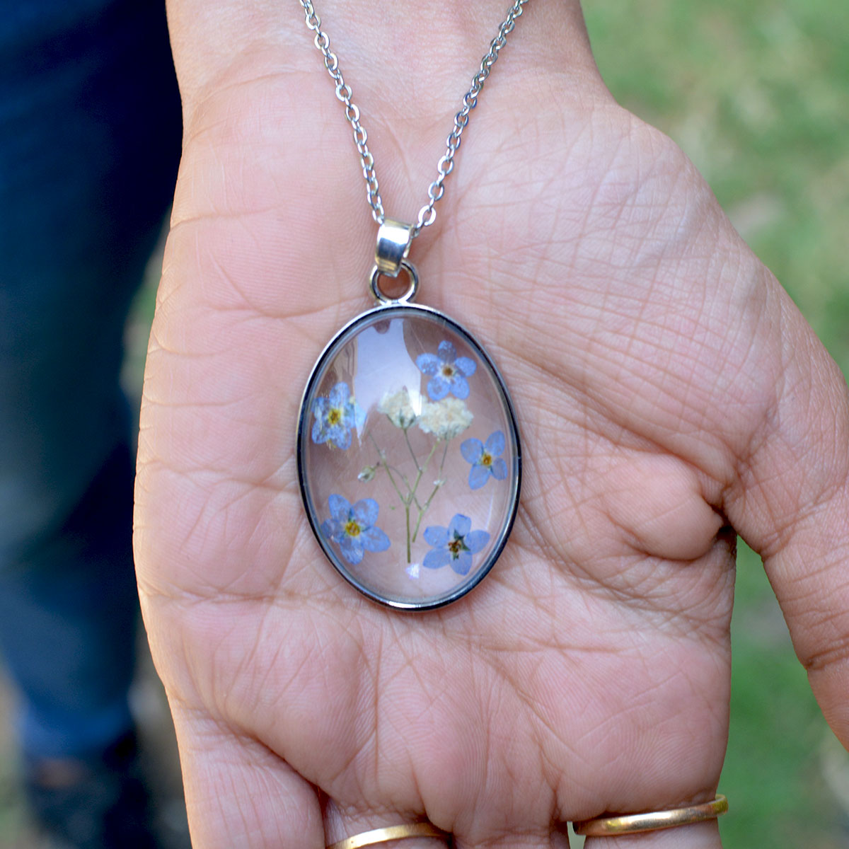 Contemplating Constellation resin pendant resting on woman’s palm showing fine handcrafted detail