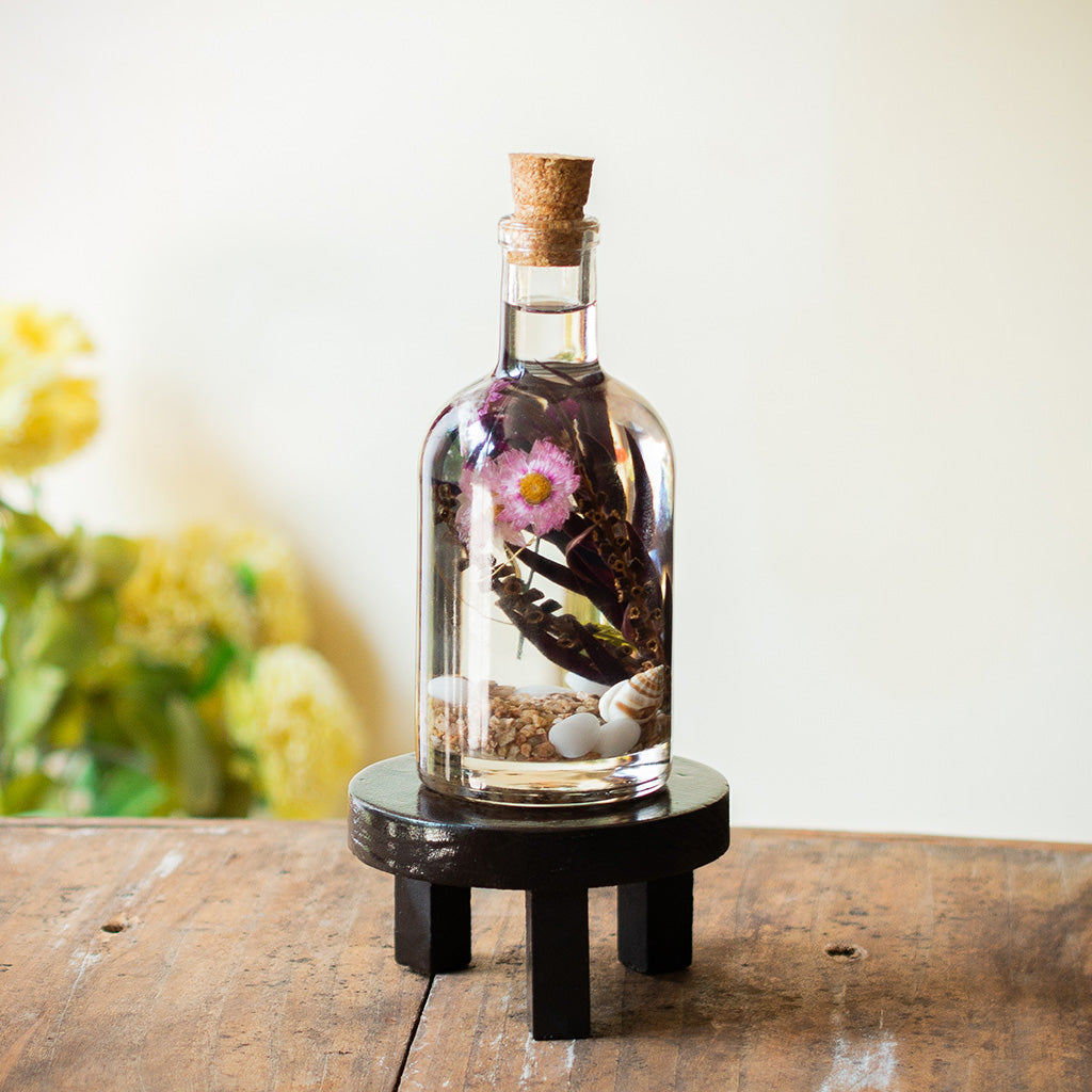 Curtained Wilderness Preserved Flower Tabletop on circular stand – serene, nature-rooted display.