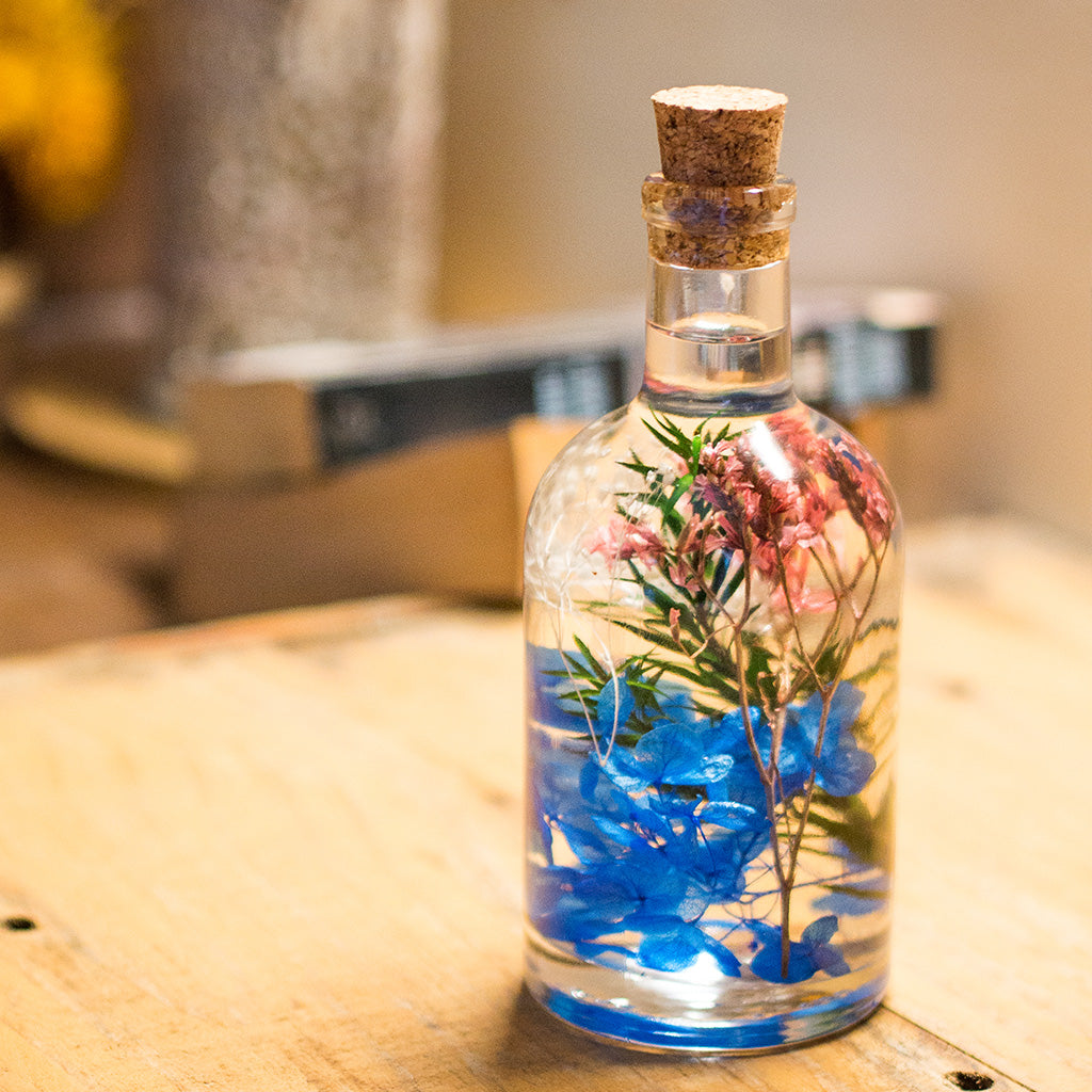 Close-up of Enchanting Fresco Preserved Flower Tabletop by myBageecha – painterly preserved blooms in dome bottle.