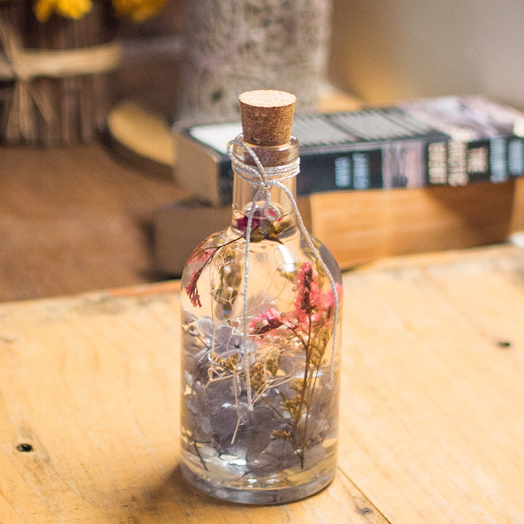 Hushed Caprice Preserved Flower Tabletop placed on table – delicate pastel décor accent.