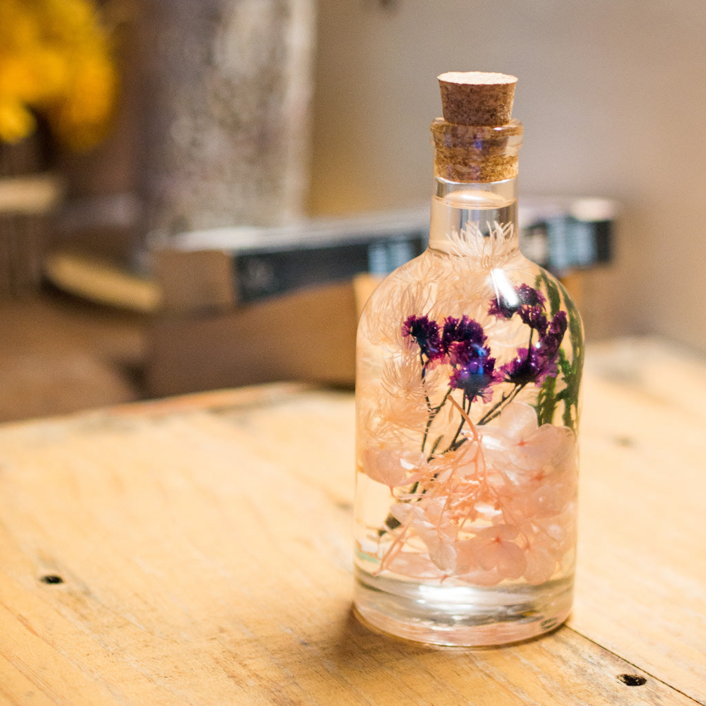 Close-up of Peachy Peep Preserved Flower Tabletop by myBageecha – peach and blush preserved blooms. Natural flowers in glass bottle.