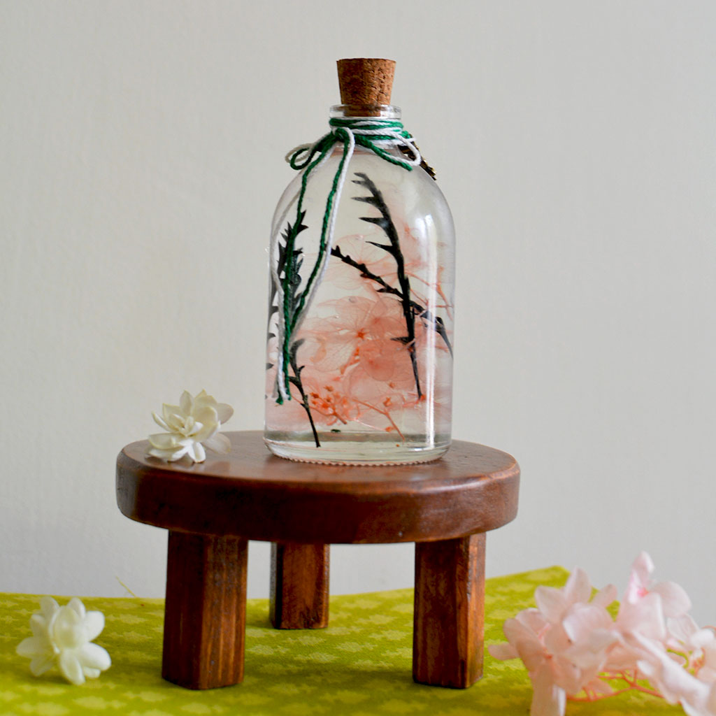 Sacramento Hooter Preserved Flower Tabletop on circular stand – cute decorative centerpiece.