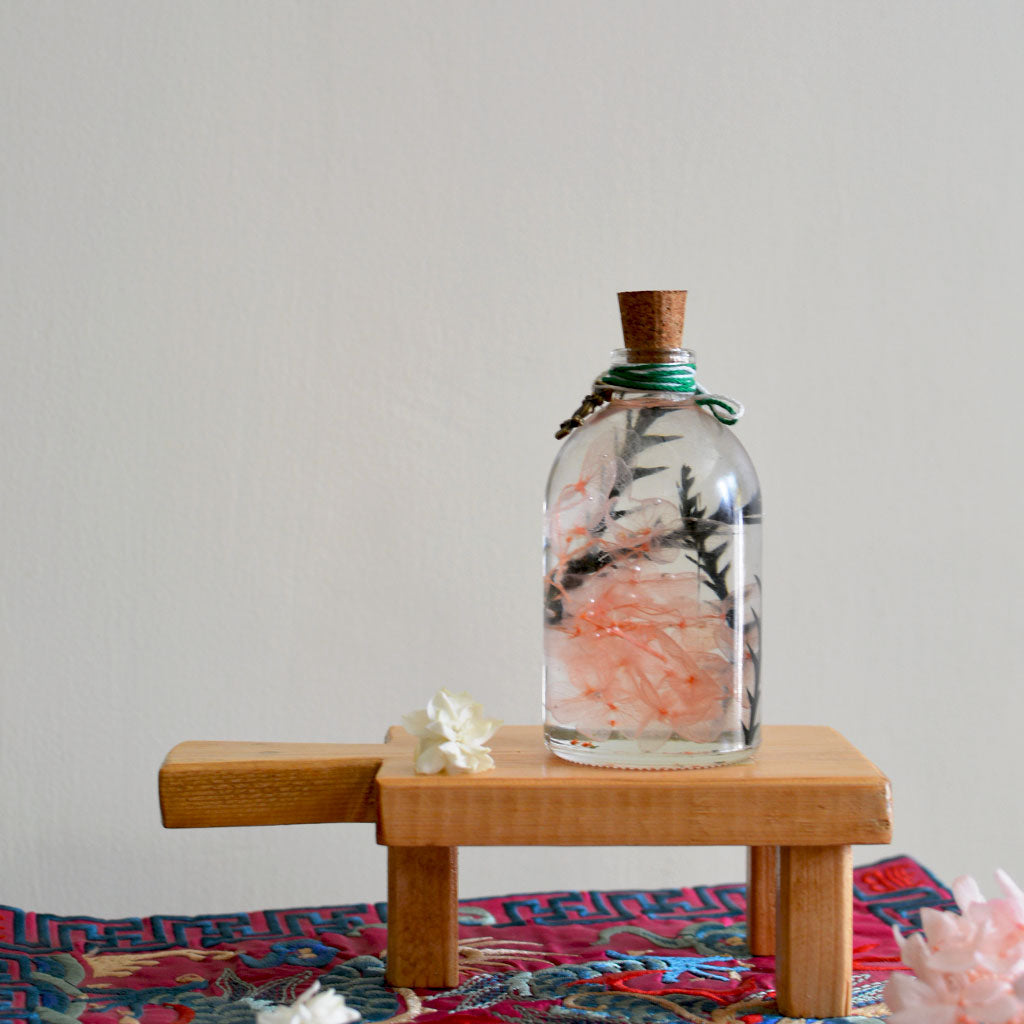 Sacramento Hooter Preserved Flower Tabletop on rectangular stand – whimsical preserved display.
