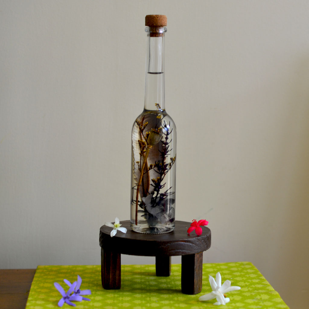 Sunkissed Souvenir Preserved Flower Tabletop on circular stand – radiant décor centerpiece.