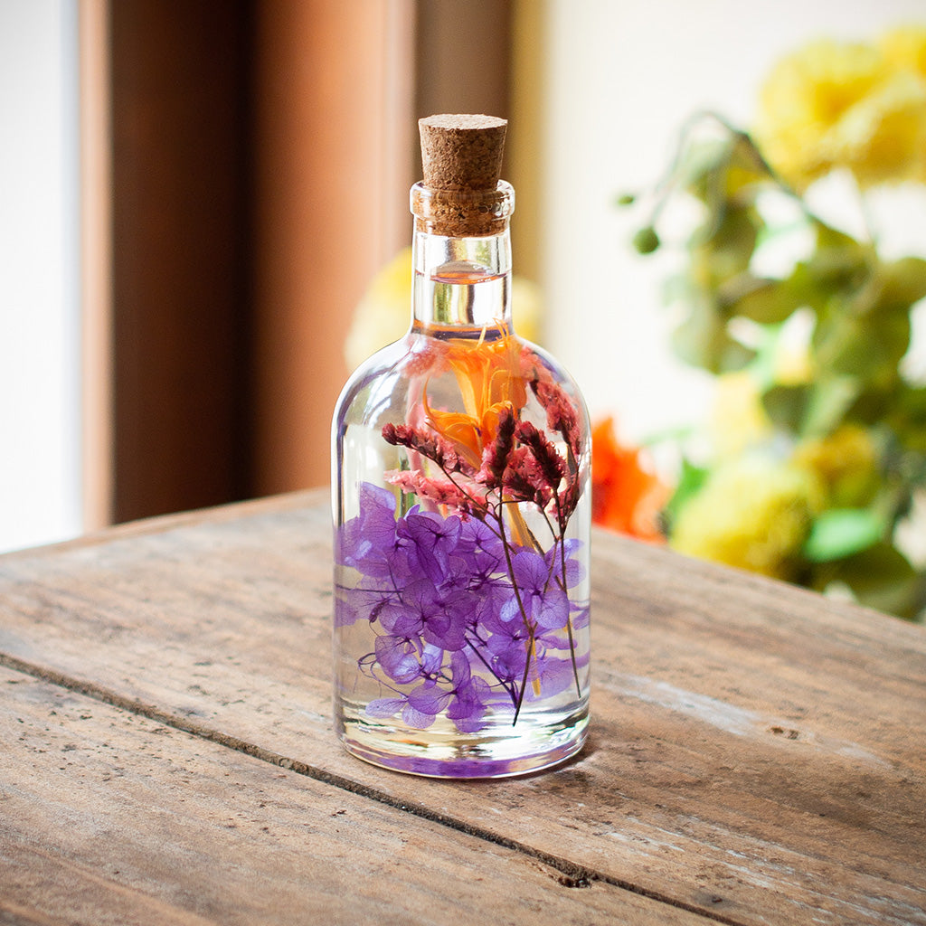 Close-up of Tumultuous Tints Preserved Flower Tabletop by myBageecha – vibrant multicolor preserved blooms in glass bottle.