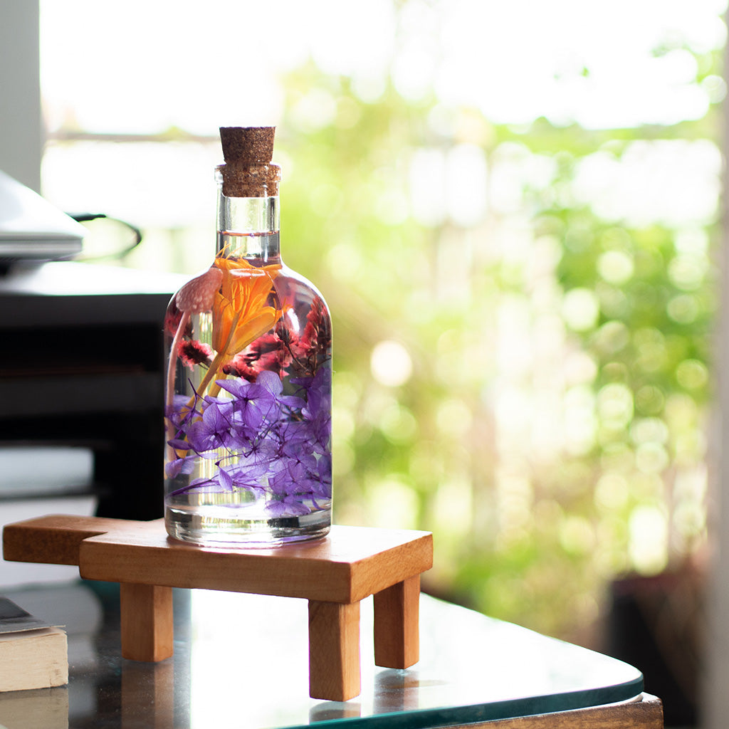 Tumultuous Tints Preserved Flower Tabletop on rectangular stand – bold, expressive preserved floral display.