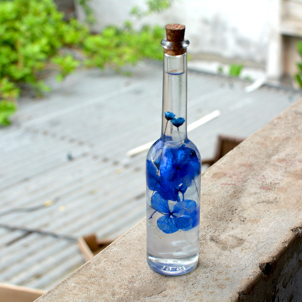 Close-up of Unfurled Camo Preserved Flower Tabletop by myBageecha – natural earthy preserved greens.