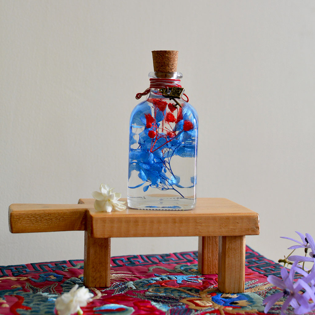 Prismatic Hues Preserved Flower Tabletop on rectangular stand – blended color preserved arrangement.