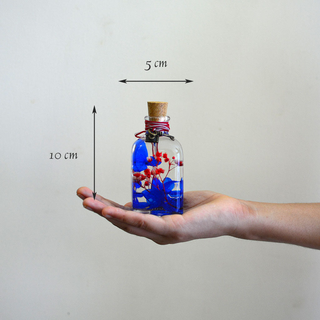 Prismatic Hues Preserved Flower Tabletop shown in hand – bright artistic décor accent.