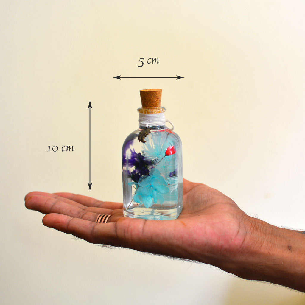 Sapphire Symphony Preserved Flower Tabletop shown in hand – elegant blue décor accent.