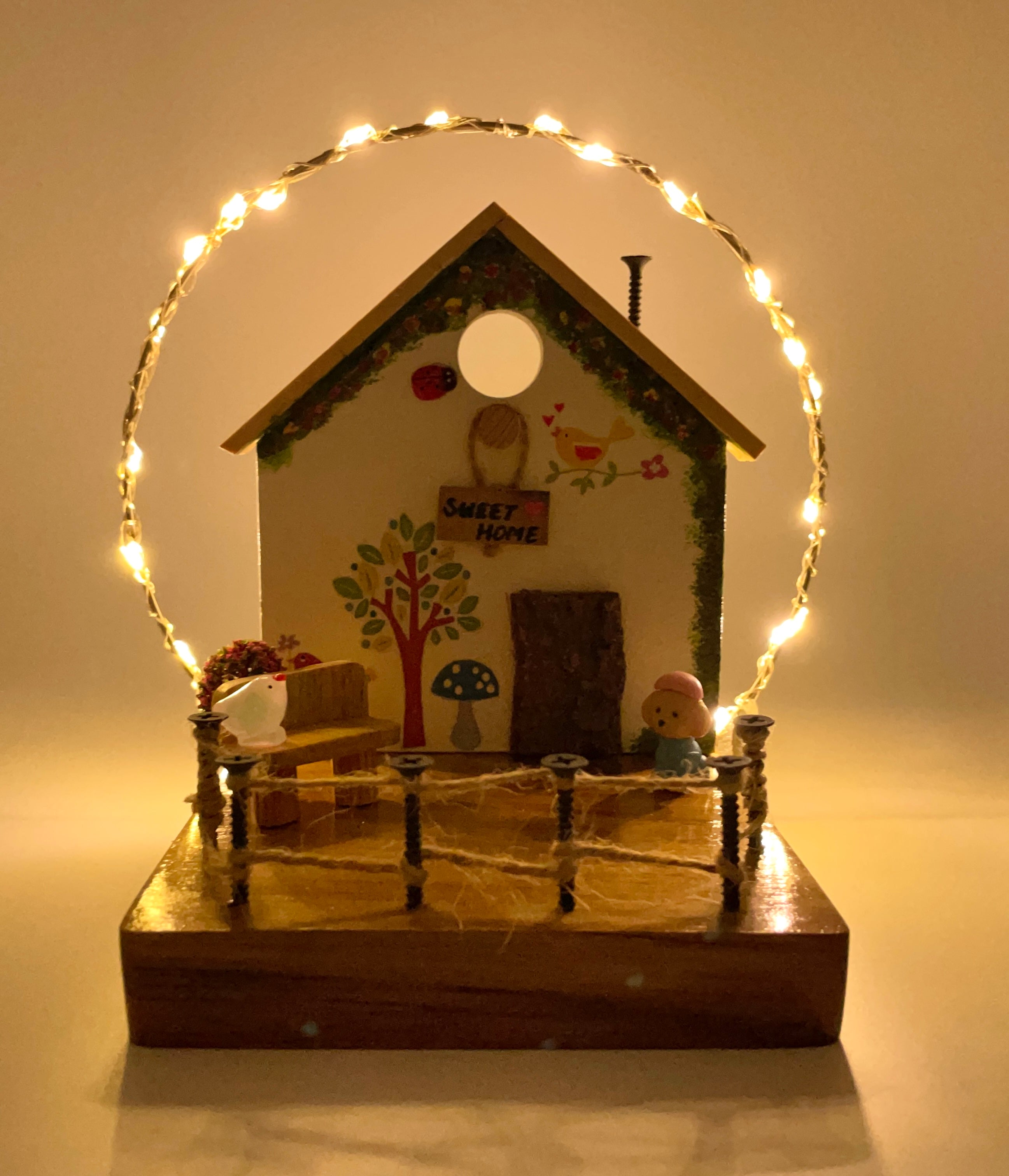 White Cottage With Bark Door & String Lights Decor