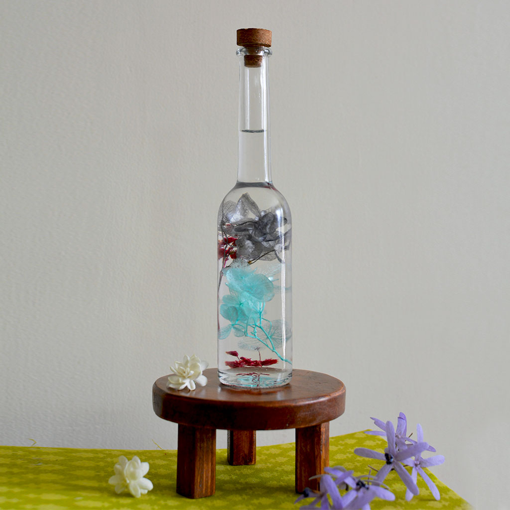 Diablerie Stir Preserved Flower Tabletop on circular stand – emotional bold décor accent.