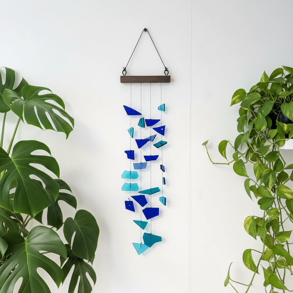 Upcycled Glass Windchime hanging on wall surrounded by plants- myBageecha